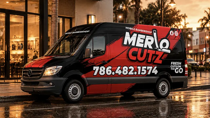 Merlo Cutz Van Wrap Design Mockup 2 MOBILE Red and black Merlo Cutz mobile barbershop van wrap design parked on a wet city street near a barbershop