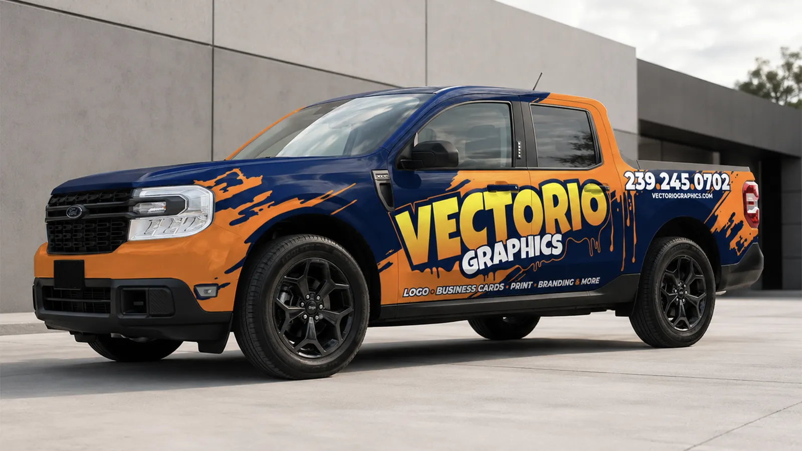 Custom commercial truck wrap mockup on a dark blue and orange Ford pickup for Vectorio Graphics, featuring a dynamic paint drip design, large company logo, design services, and contact information on the side.